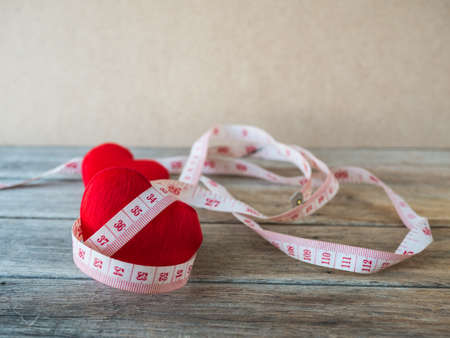 heart with measurement tape on wood background,の写真素材