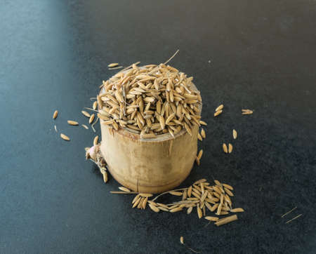 raw rice in bamboo on blackの写真素材