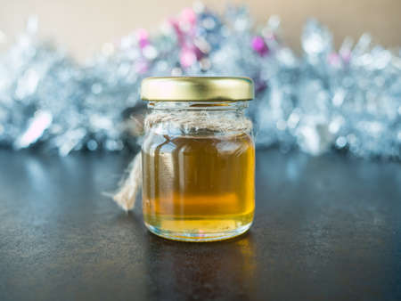 Jar of honey on wooden black tableの写真素材