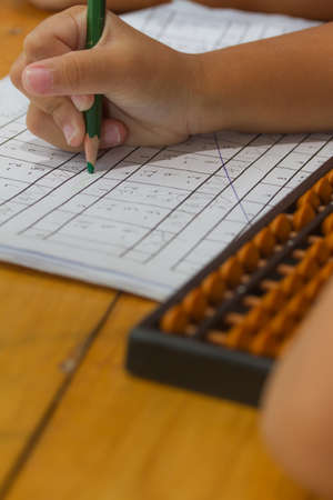 write number on paper, wooden table,の写真素材