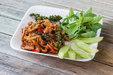 Stir-fried with spicy, thai food, rice in cup on wooden tableの写真素材