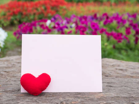 Red heart and paper card on flower background, rock retro background,の写真素材