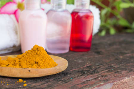 powder turmeric in wooden ladle, blur spa product background,の写真素材