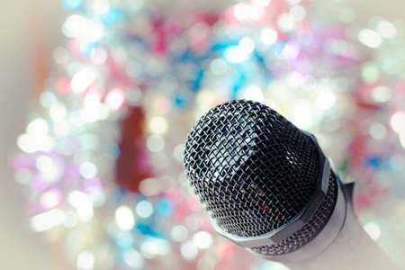 Vintage microphone, Close up of microphone in concert hall or conference room with lights in backgroundの写真素材