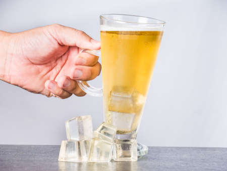 Hand was holding a glass of beer, Beer in glass on white,の写真素材
