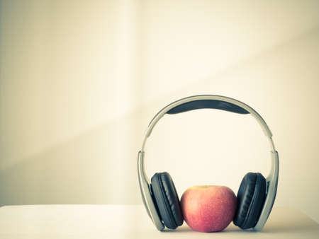 Red Apple and earphone in image vintage and retro,の写真素材