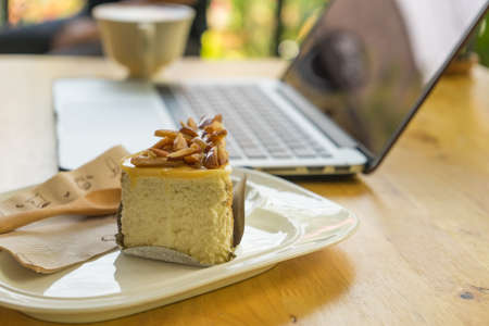 Bakery almond in plate on blurred notebook background,の写真素材