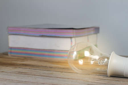 light bulb on books background, Light from light bulbs on table,の写真素材