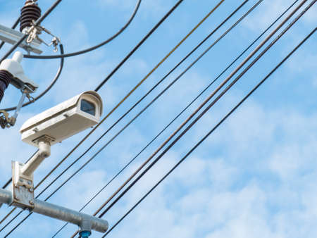 closed-circuit camera on Electric transformers and white clouds background,