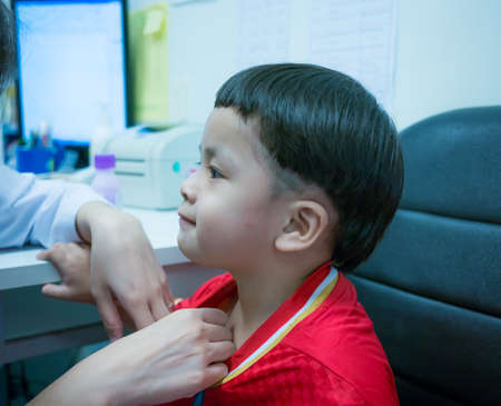 Cute little boy and doctor examined body,