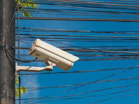 closed-circuit camera on white clouds background, closed-circuit camera on electric pole,の写真素材