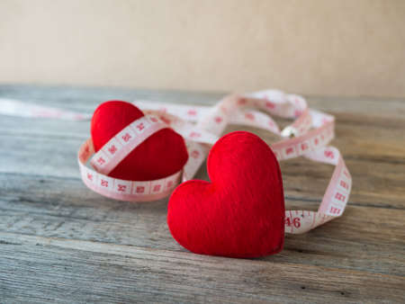heart with measurement tape on wood background,の写真素材