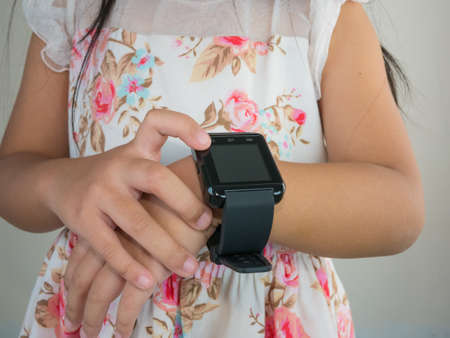 Wearing touchscreen smartwatch in hand girl,の写真素材