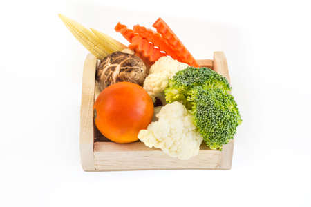 Total vegetables on wooden tray, white broccoli, red tomato,の写真素材