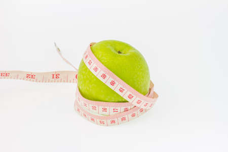 green apple and  measuring tape on white background.の写真素材