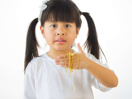 Gold in hand on blur image little girl,の写真素材