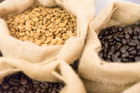 Raw seed coffee in sack, focus select color brown raw coffee,の写真素材