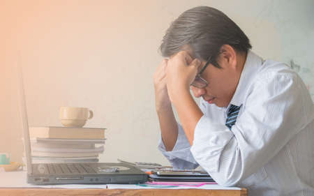 Businessman hand catching head on dirty wall background,の写真素材