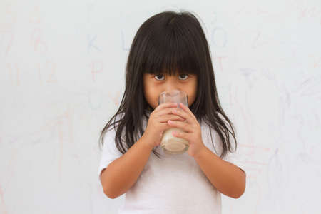 little girl drinking milkの写真素材