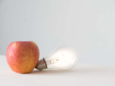 Light bulb in red apple on white background,の写真素材