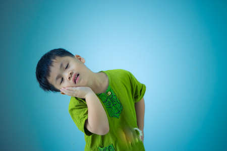 Asian cute kid toothache on blue color background,の写真素材