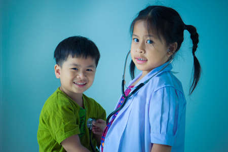 Asian cute children playing as doctor and patientの写真素材