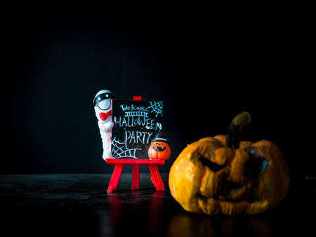 Welcome halloween party notice board on black background, blurred image pumpkin front Halloween party,の写真素材
