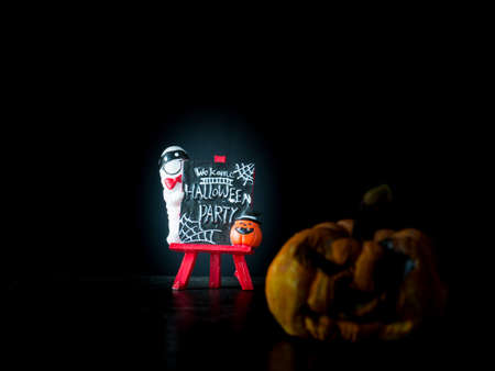 Welcome halloween party notice board on black background, blurred image pumpkin front Halloween party,の写真素材