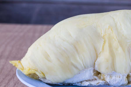 Durian on plate and on wooden background, King of fruits.の写真素材