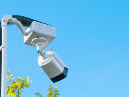 closed-circuit camera on blue clouds background,