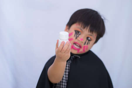 Drug in hand kid make up Halloween on white background,