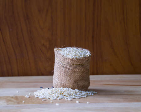 Rice in sack on wooden table,の写真素材
