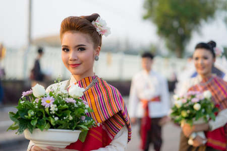 KHONKAEN,THAILAND-NOVEMBER 3, 2017:Thai cute Girls participate in a carnival to celebrate the Loy Kratong Festival.She stay on a small rafts-Kratong. November 3, 2017 in Khonkaen, Thailand.のeditorial素材