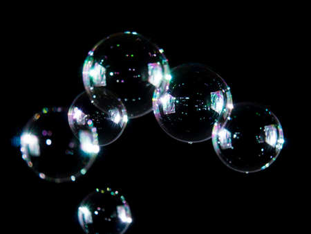 Blurred soap bubbles on black background, Photo of soap bubble, soap bokeh background,