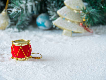 Red drum on snow, blurred tree cristmas background,の写真素材