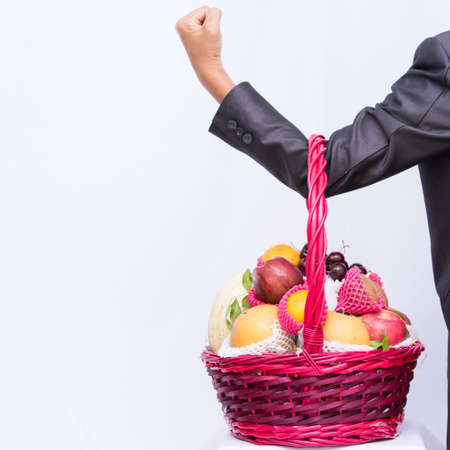 Group fruit in basket on white background, hand business holding basket fruit,の写真素材