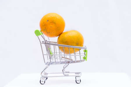 Orange fruit in cart on white background,の写真素材