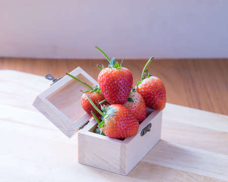 Strawberry in wooden box on pattern wooden background,の写真素材