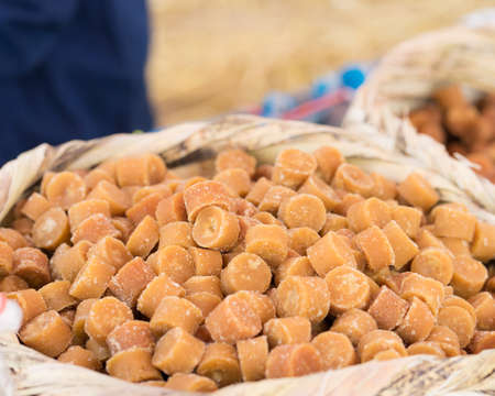 Fresh homemade molasses candies in bamboo basket,の写真素材