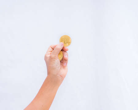 Cryptocurrency coin gold in hand on white  background,