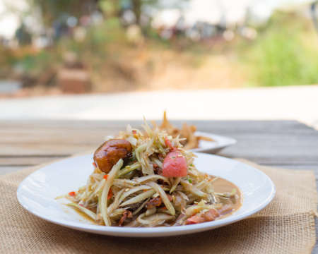 Papaya pok in sackcloth on table background,