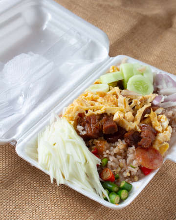 shrimp paste rice in white foam box on sack background,