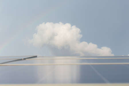 White clouds with solar cells in frontの写真素材