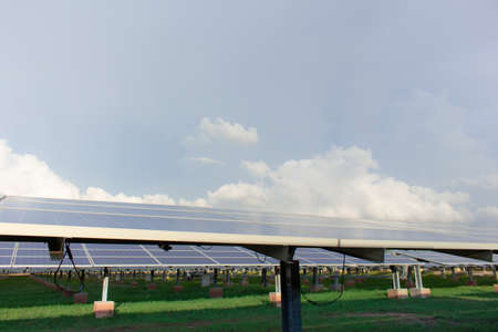 Large number of solar cell panels on white clouds background,
