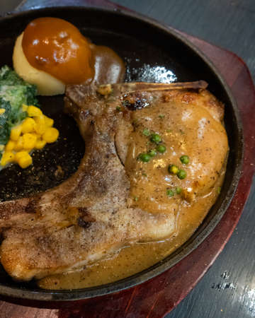 Meat steak and mash in the tray on the tableの写真素材