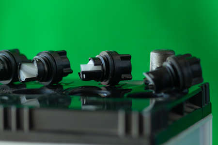 The battery cover is open on top on green colour background,の写真素材