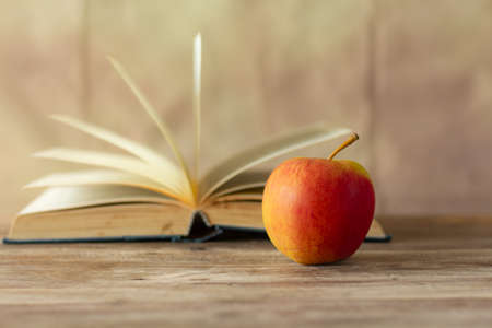Red apple on blurred a book retro wall background,の写真素材