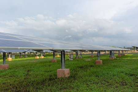 Large number of solar cell panels on white clouds background,