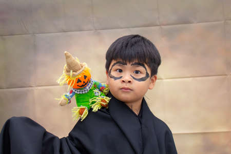 Asian Cute a boy and toy halloween on vintage background,の写真素材