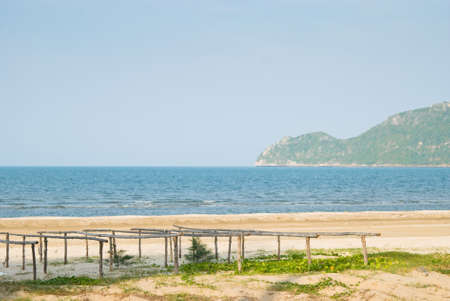 Bamboo stick for drying fish on beautiful beach